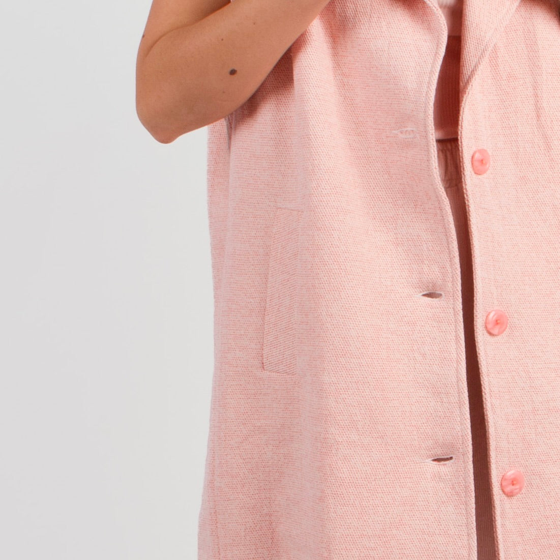 Lucewear: femme portant une veste sans manche en tweed rose